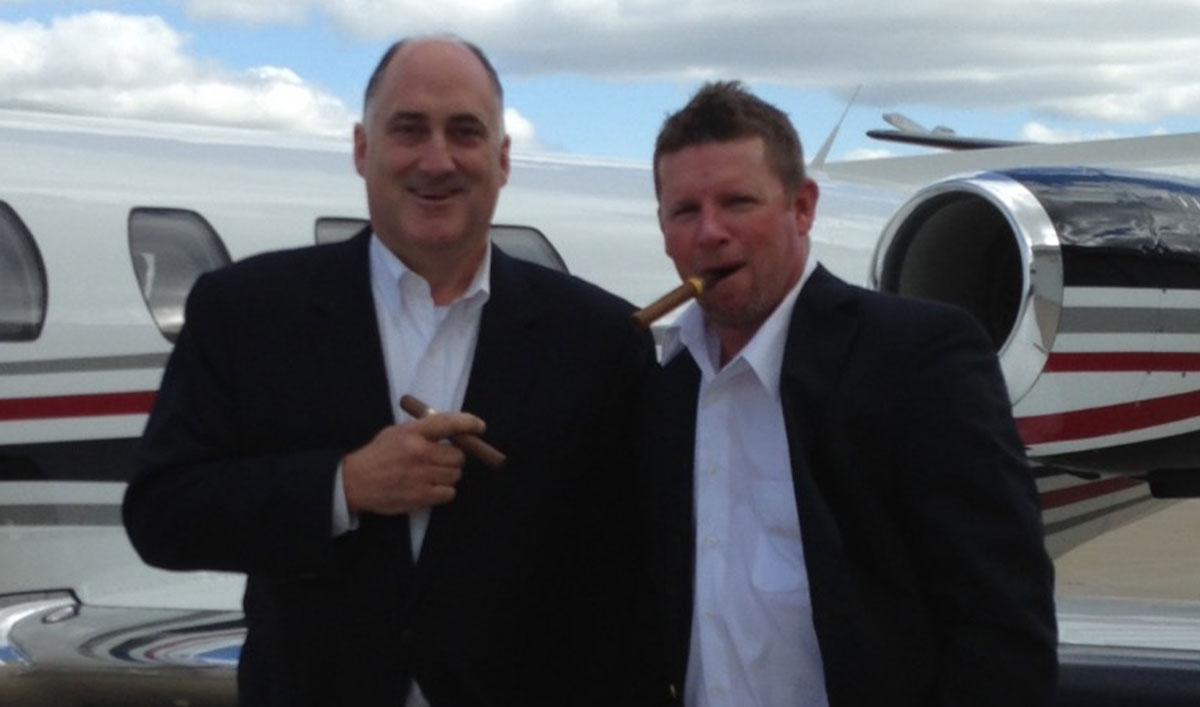 The BBI team getting on the plane, smoking cigars.