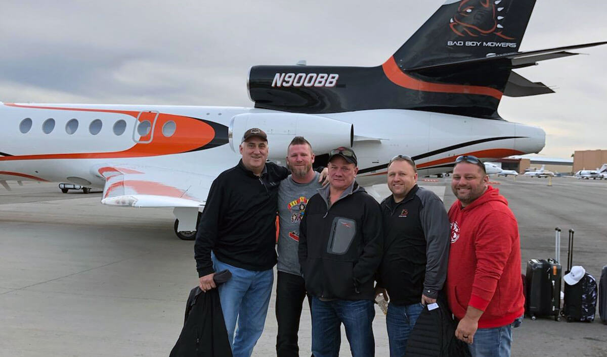 The BBI team getting on the Bad Boy Mowers Plane.